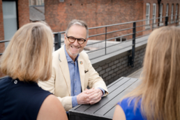 Photo Richard Colley talking to 2 people